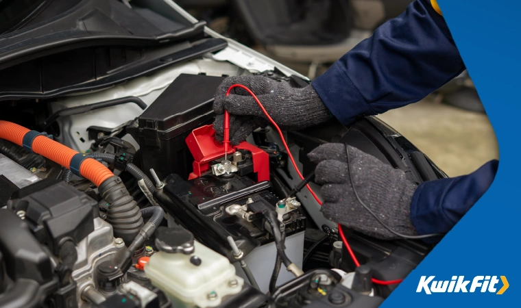 mechanic testing a car battery